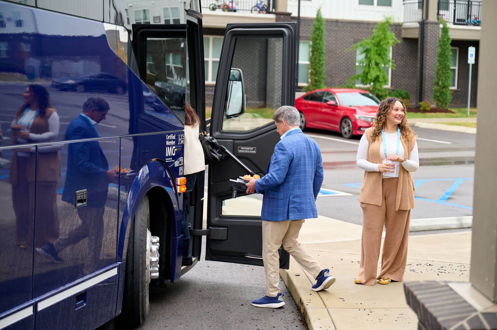 Tour guests stepping off the bus at a Holladay Ventures development