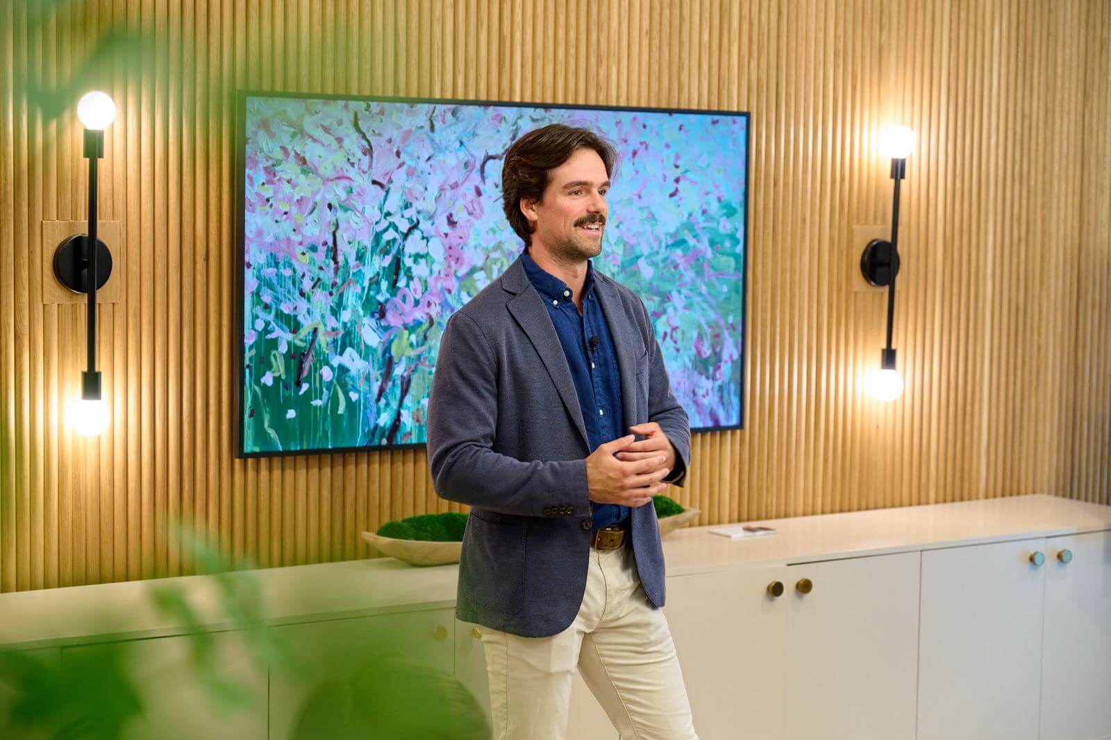 Speaker presenting at the media wall