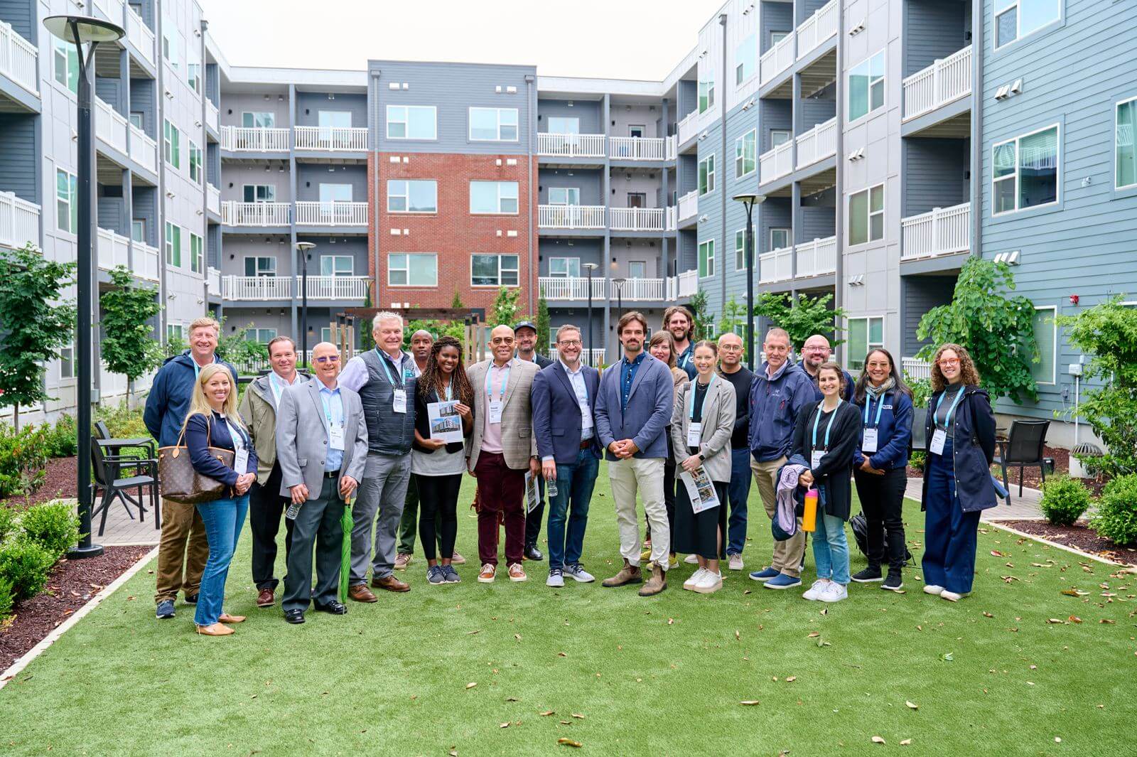 Tour group gathered in the courtyard between residential buildings