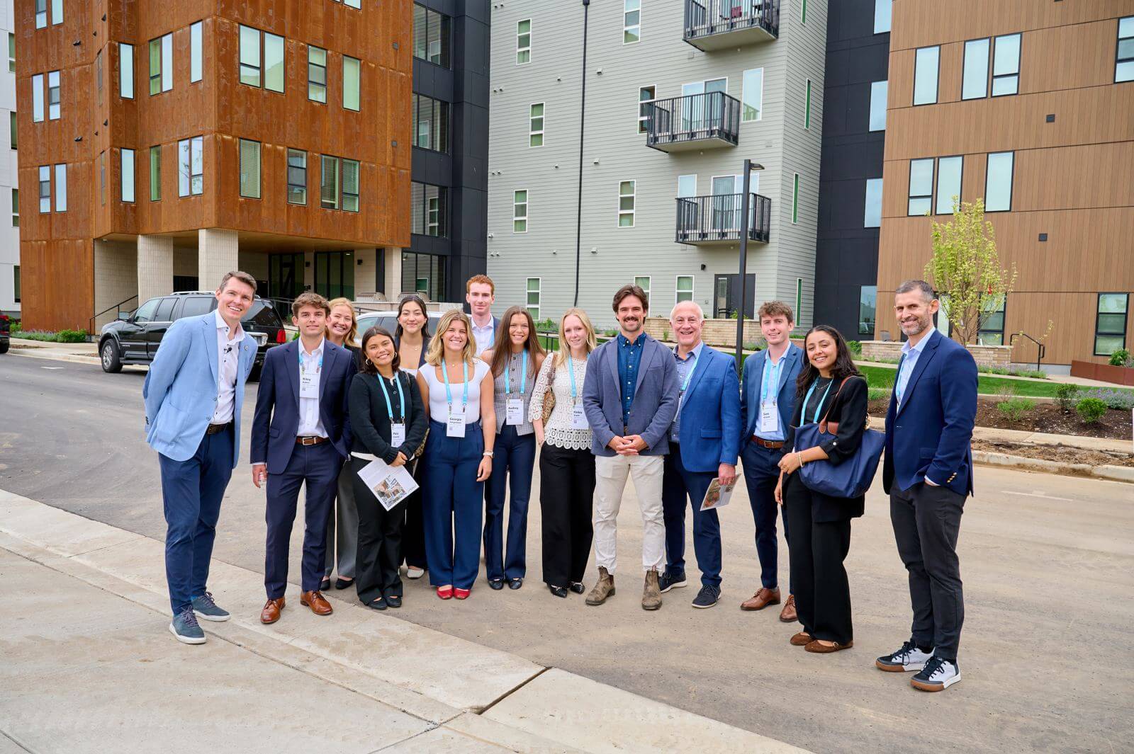 Group photo in front of a Holladay development